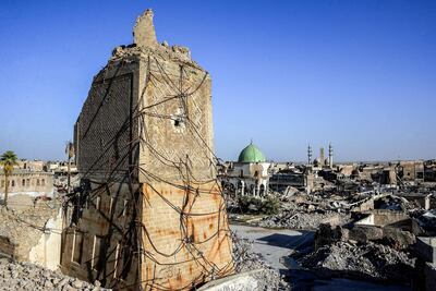 The base of the destroyed Al Hadba leaning minaret in the Old City of Mosul, with the dome of the destroyed Al Nuri Mosque seen behind. AFP