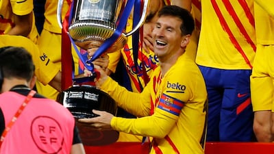 Barcelona's Lionel Messi lifts the trophy with celebrating teammates after winning the Copa Del Rey final against Athletic Bilbao. Getty
