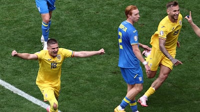 Denis Dragus of Romania celebrates making it 3-0. EPA