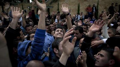 Palestinian singer and the last season's Arab Idol winner Mohammed Assaf, centre, joins hundreds of Palestinian youths cheering, while waiting for a chance to compete in the Arab world's premier talent show Arab Idol, at the luxury Grand Park Hotel, in the West Bank city of Ramallah on Monday, March 17, 2014. AP
