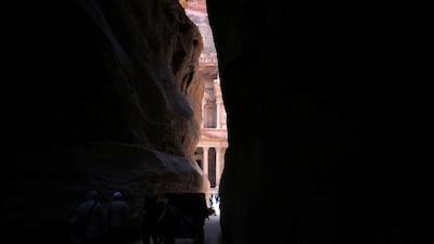 Tourists ride a horse-drawn cart in front of the treasury site. Reuters
