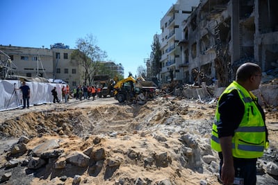 Construction workers begin clearing the site of a missile strike in Tel Aviv, Israel. Getty Images