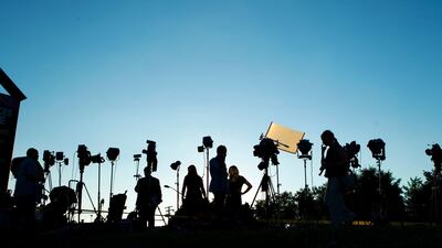 TV crews waiting for a news conference line up at the side of the road across the newspaper office building where multiple people were shot this afternoon inside of the newsroom, in Annapolis, Md., Thursday, June 28, 2018. (AP Photo/Jose Luis Magana)