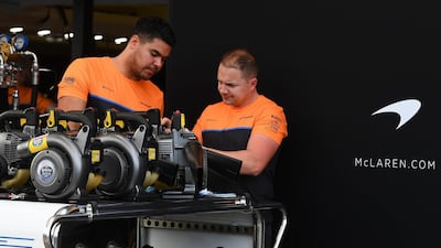 Members of the McLaren team work in pit lane at the Albert Park circuit ahead of the Formula One Australian Grand Prix in Melbourne. AFP