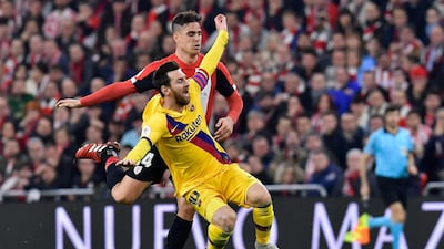 Barcelona attacker Lionel Messi is tackled by Athletic Bilbao's Dani Garcia. AP
