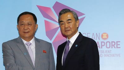 North Korea's Foreign Minister Ri Yong Ho and China's Foreign Minister Wang Yi meet in Singapore on August 3, 2018. Reuters