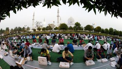 People observing Ramadan wait to break the day’s fast outside the Sheikh Zayed Grand Mosque last year. Even social media activity changes during the holy month. Christopher Pike / The National