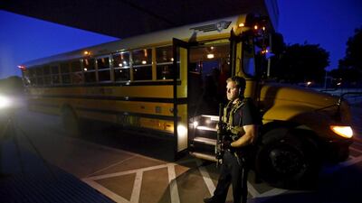 A police officer stands near a school bus used to evacuate attendees of the Mohammad Art Exhibit and Contest sponsored by the American Freedom Defense Initiative. Mike Stone / Reuters