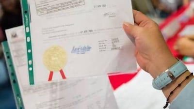 Refusing to be identified, a Dubai-based travel agent sells an affidavit of support and guarantee for Dh 300. Duncan Chard for the National