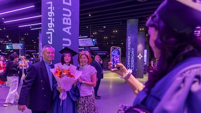 A graduate celebrates her academic success with family