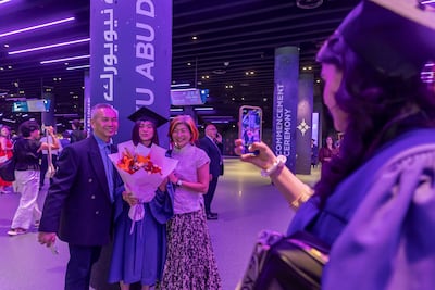 A graduate enjoys a picture perfect moment at the Etihad Arena ceremony. Antonie Robertson / The National
