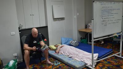 Residents take refuge at a local club in Taree, 350km north of Sydney, as firefighters try to contain dozens of out-of-control blazes that are raging in the state of New South Wales. AFP