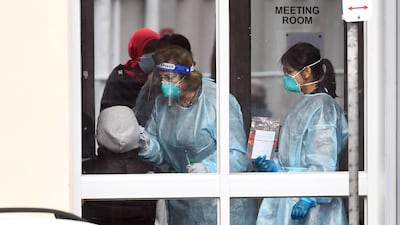 Medical staff perform a Covid-19 test on a resident in Melbourne. AFP