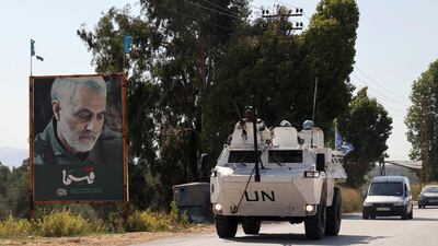 An armoured personnel carrier belonging to the Unifil drives past a poster of Qassem Suleimani, slain commander of Iran's Islamic Revolutionary Guard Corps, in the Marjayoun area of southern Lebanon. AFP