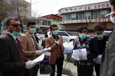 Activists in Kabul distribute fliers with information about the coronavirus on March 16, 2020 as the number of confirmed cases in Afghanistan reached 21. AP Photo