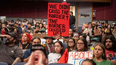 A woman holds a sign during a city council meeting demanding Immigration and Customs Enforcement (ICE) to be removed from the community, as demonstrations continue in response to federal immigration operations in the Whittier neighbourhood of Los Angeles. AFP