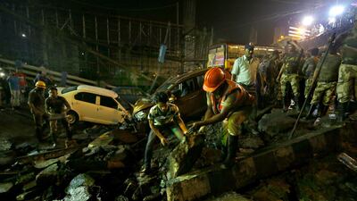 People gather while rescue personnel work at the site. EPA