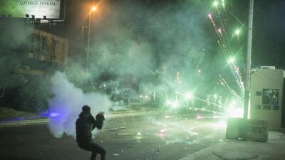 An anti government protester fires fireworks at riot police as they clash during a second day of violence. Getty Images