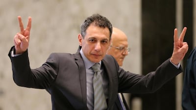 Mr. Zakka flashes victory signs upon his arrival at the presidential palace. AP Photo