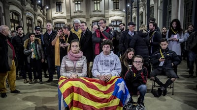 People hold a Catalan flag while following election results at the Esquerra Republicana de Catalunya ERC party headquarters in Barcelona. Angel Garcia / Bloomberg