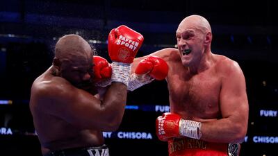Tyson Fury lands a punch on Derek Chisora during their WBC heavyweight world title fight. Reuters