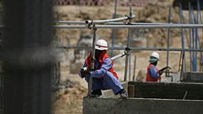 Construction crews work on the foundation of the Masdar Institute in Masdar City on the outskirts of Abu Dhabi.