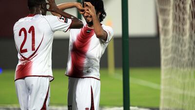 Al Wahda's Salem Salah and Papa Waigo celebrates behind the net after scoring the third goal against Al Shaab during their Etisalat Cup. Ravindranath K / The National