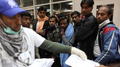 Mohamed Fares of the International Organization for Migration helps Bangladeshi refugees fleeing from Libya.