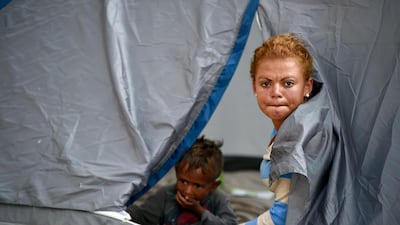 A Central American migrant mother and her child rest in a tent at a temporary shelter in Irapuato, Guanajuato state, Mexico. AFP