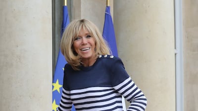 Brigitte, wearing a Balmain Breton top and slim-fit trousers, at the Elysee Palace on April 10, 2018. AFP
