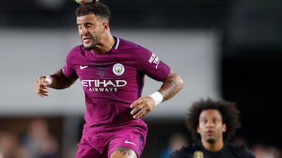 Manchester City's Kyle Walker, left, heads the ball in front of Real Madrid's Marcelo. Paul Buck / EPA