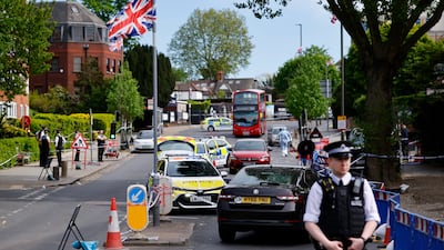 Police officers at the scene where two Jewish men were seriously injured after being stabbed in Golders Green, north London. EPA