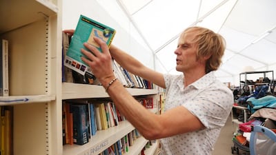 Graham Box volunteers at the St Andrews Centre thrift shop. Fatima Al Marzooqi / The National.