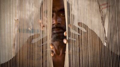'Threads' by Lisa Kristine. Speaking about the subject of the photograph, she says: "He is more than 50 years old and is enslaved weaving carpets to pay off a modest loan he took 12 years ago. He doesn’t know if he’ll ever be free to work for someone else."
