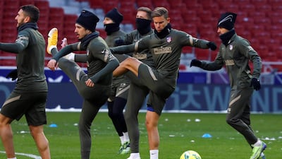 Atletico Madrid's players, including Marcos Llorente, centre, during a training session at Wanda Metropolitano Stadium. Atletico were forced to hold Monday's training session at their stadium due to severe snow in the Spanish capital. EPA