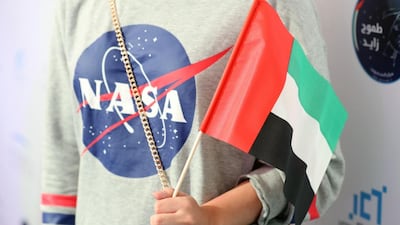 People attend a live screening of the launch of the UAE's first astronaut into space, at Mohammed bin Rashid Space Centre in Dubai. Chris Whiteoak / The National