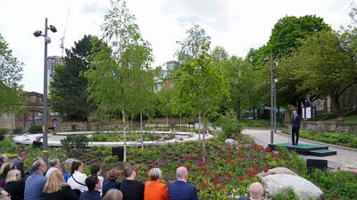 People watch on as Prince William makes a speech. AFP