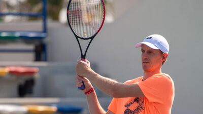 Tennis player Kevin Anderson wears the red wrist band signifying his support for the Special Olympic World Games during a Tennis clinic held during the Mubadala Tennis Championships in Abu Dhabi. Courtesy Special Olympics World Games Abu Dhabi Twitter