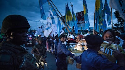 Presidential Guard and police forces link arms as they control the crowd before the arrival of the President Felix Tshisekedi at the airport of Goma, eastern DR Congo. AFP