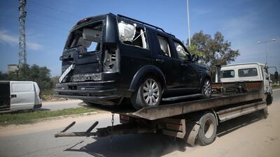 One of the cars of the Palestinian Prime Minister's convoy that was hit by an explosion being towed away to the Gaza strip Erez crossing, in Beit Hanun, the northern access point into the coastal Palestinian territory. Mohammed Abed / AFP