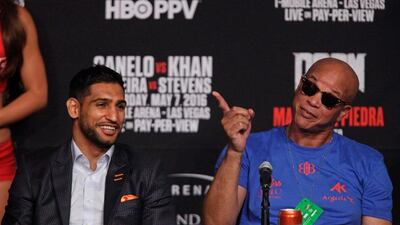 Amir Khan, left, and trainer Virgil Hunter appear to share a joke during the press conference. John Gurzinski / AFP