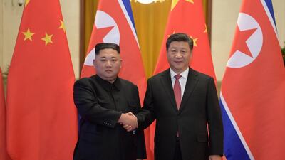 Kim Jong-un and Xi Jinping shake hands before talks at the Great Hall of the People in Beijing. AP Photo