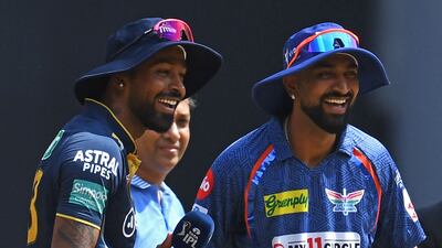 Gujarat Titans captain Hardik Pandya, left, alongside his brother Krunal, skipper of Lucknow Super Giants, before the start of their IPL match at the Narendra Modi Stadium in Ahmedabad on May 7, 2023. AFP