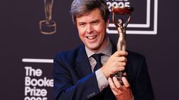 Author David Szalay with the trophy after winning the 2025 Booker Prize. PA