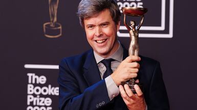 Author David Szalay with the trophy after winning the 2025 Booker Prize. PA