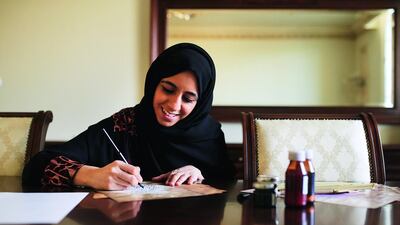 Hamda Al Hashemi, who has learnt calligraphy for one year, practices at her home in Dubai. Sarah Dea / The National