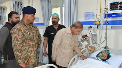 Pakistan's Prime Minister Shehbaz Sharif visits children admitted to hospital in Quetta after they were wounded in the school bus bombing. AFP