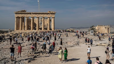 Tourists visit the Acropolis hill and 2,500-year-old Parthenon temple. AP