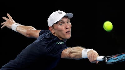 Mitchell Krueger of the US reaches for a backhand return to Serbia's Novak Djokovic during their first round match at the Australian Open. AP