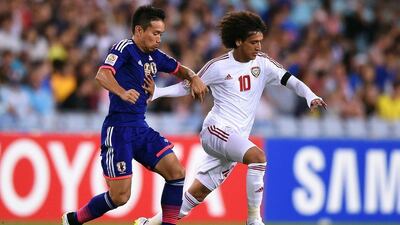 Yuto Nagatomo, left, of Japan chases down Omar Abdulrahman, right, of UAE during their Asian Cup quarter-final match on Friday in Sydney. Paul Miller / EPA
